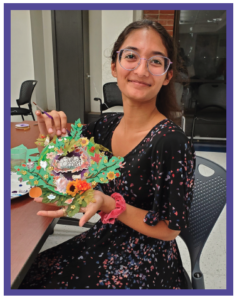 student holding a craft